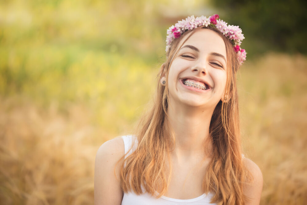 Young girl with braces smiling and enjoying summer vacation